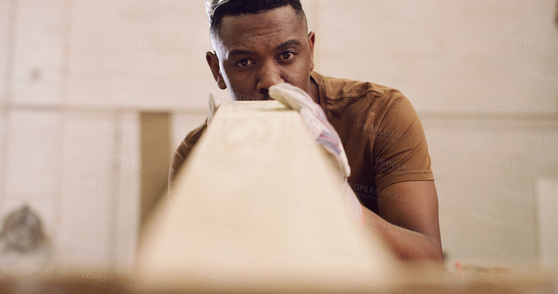 Buy stock photo Carpenter, man and inspection in workshop with woodwork, remodeling project or furniture production. Black person, check timber or quality control with craftsmanship, carpentry or manufacturing plan.