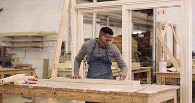 Buy stock photo Carpenter, man and sanding in workshop with timber, woodwork and furniture restoration project. Woodworker, black person and PPE in factory with carpentry equipment, manufacturing and craftsmanship.