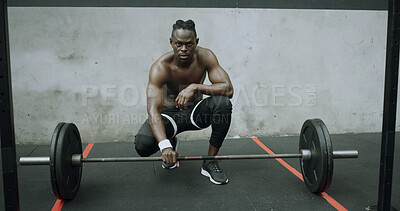 Buy stock photo Fitness, serious and black man with barbell in gym, workout break or strength training with space. Bodybuilder, shirtless person and portrait with weights for power, muscle or rest with determination