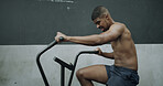 Gym, fitness and man on exercise bike for cardio workout, strength training or muscular endurance. Athlete, african person and intense challenge on stationary bicycle for burning calories or sweating