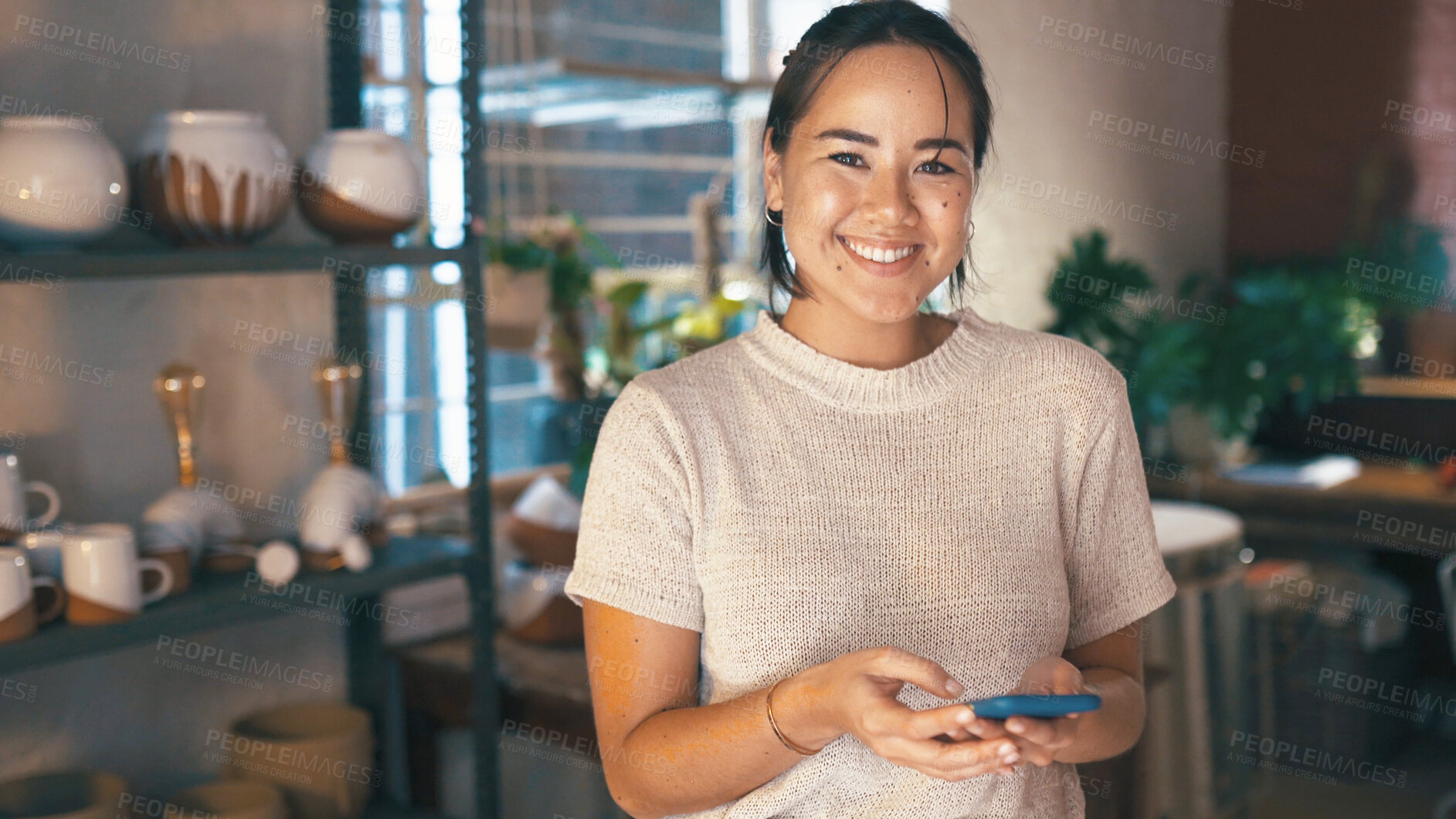Buy stock photo Phone, portrait and typing with woman in pottery boutique for management of small business. App, schedule and startup with happy store owner in ceramics gallery for decoration or retail sale