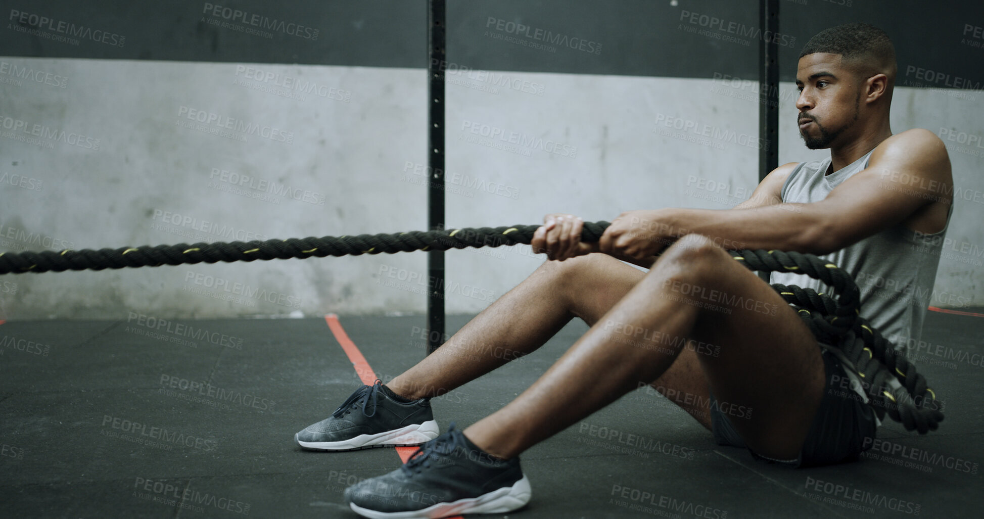 Buy stock photo Man, battle ropes and training on gym floor with pull, intense workout and resilience with challenge. Person, fitness and power with breathing, resistance and exercise for muscle benefits with gear