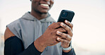 Man, hands and fitness with phone for social media, sport app or outdoor workout routine. Active, male person or runner typing with smile on mobile smartphone for exercise, health tips or guide