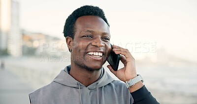 Buy stock photo Black man, phone call and happy with fitness on sea promenade with conversation on break. African person, runner and space in sky with smartphone, discussion and smile for exercise on ocean boardwalk