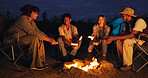 Friends, camping and fire with marshmallow at night for travel, adventure and social gathering. Smile, people and flames for smores snack, group reunion and bonding together on vacation in wilderness