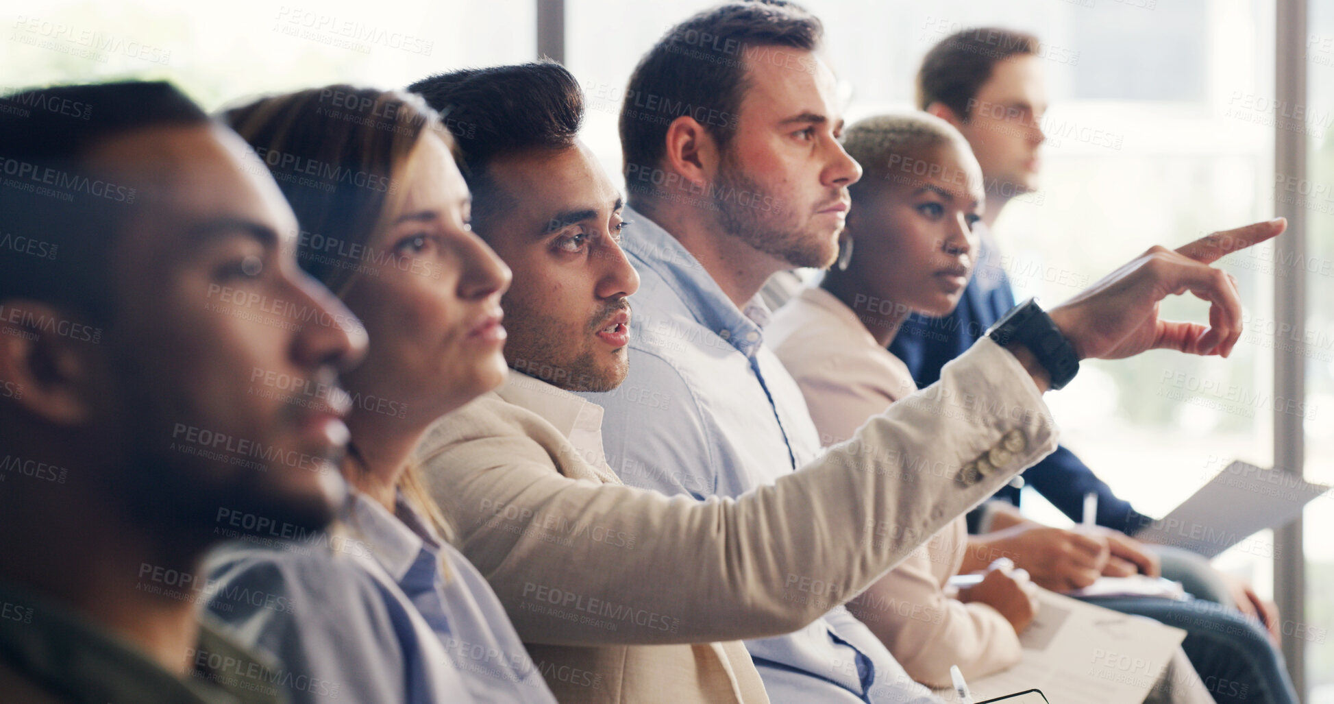 Buy stock photo Man, audience and point at conference with business people with attention, insight or feedback. Person, crowd and gesture for review, workshop or group with notes at corporate training convention