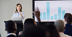 Presentation, audience and woman with question for conference, training and meeting. Business people, discussion and hand raised in workshop, convention or seminar for financial coach with graph