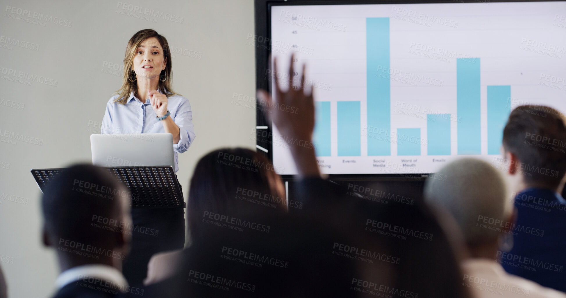 Buy stock photo Presentation, audience and woman with question for conference, training and meeting. Business people, discussion and hand raised in workshop, convention or seminar for financial coach with graph