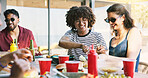 Serve, bbq and relax with friends outdoor for social reunion, lunch and summer vacation. Gathering, party and barbecue cookout with group of people eating food in backyard of home for holiday