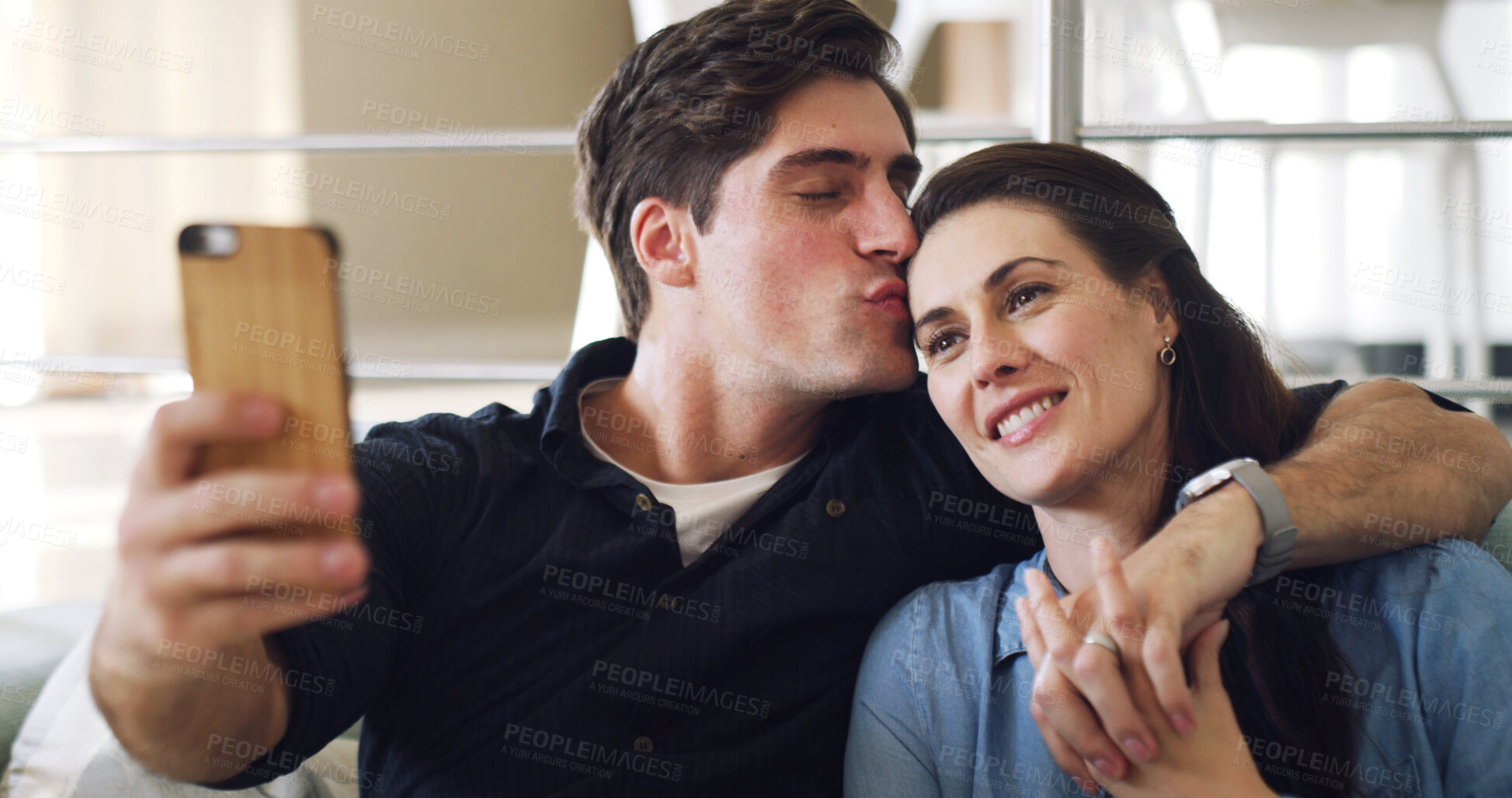 Buy stock photo Happy couple, selfie and kiss on sofa in home with bonding, connection or care with web post. Man, woman and smile with partner, photography or hug with love for social media on couch at apartment