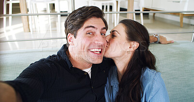 Buy stock photo Kissing, selfie and happy couple on sofa, portrait and profile picture for memory, home and funny. Smile, man and woman on in living room, relax or photography for social media post, laughing or love