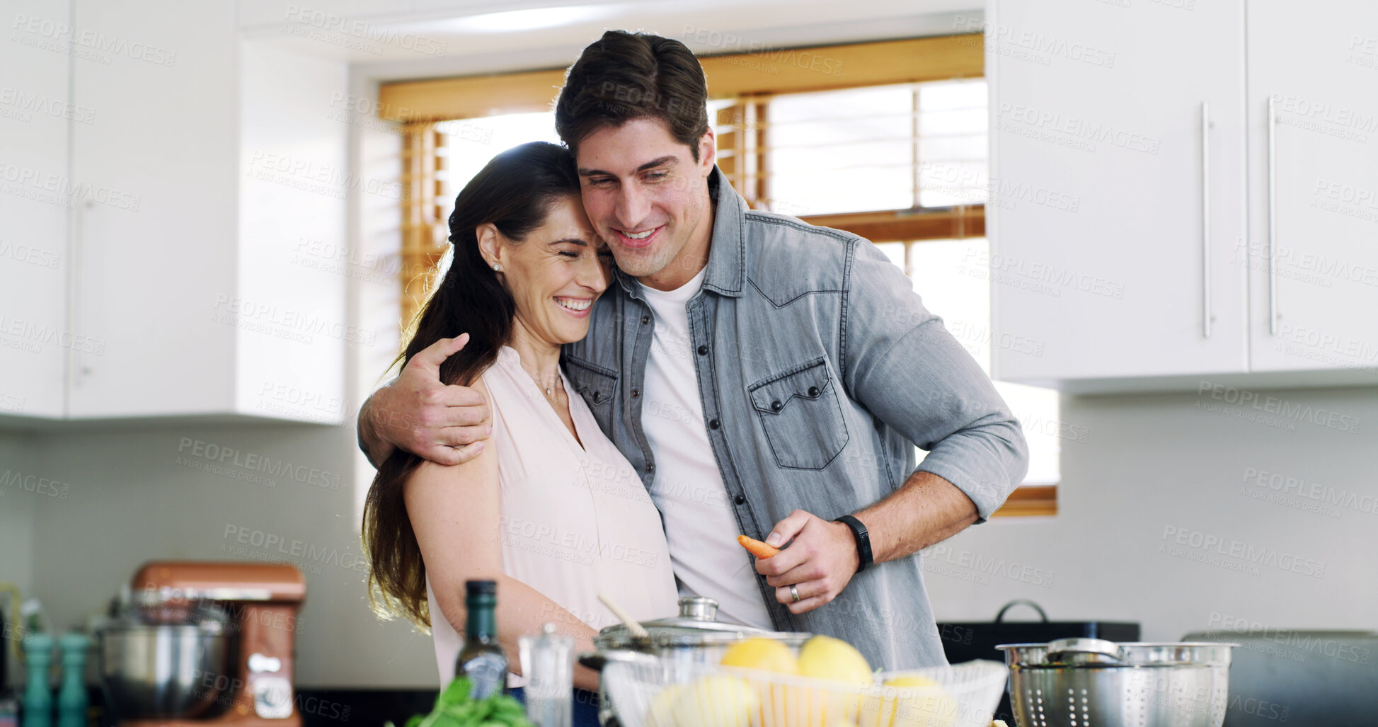 Buy stock photo Home, cooking and couple in kitchen, hug and bonding together for relationship, recipe and diet plan. Embrace, ingredients or man with woman, funny and prepare meal for nutrition, love or support