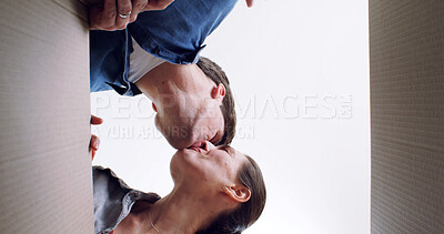 Buy stock photo Unpacking boxes, kissing and low angle with couple in new home, property investment and marriage. Rental apartment, cardboard or man with woman, romance and love for relationship or real estate goals