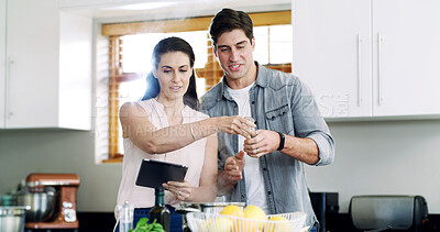 Buy stock photo Help, cooking and happy couple in kitchen, tablet for online recipe and website for nutrition info. Home, man and tech for ingredients, woman and reading instructions for health meal and connection