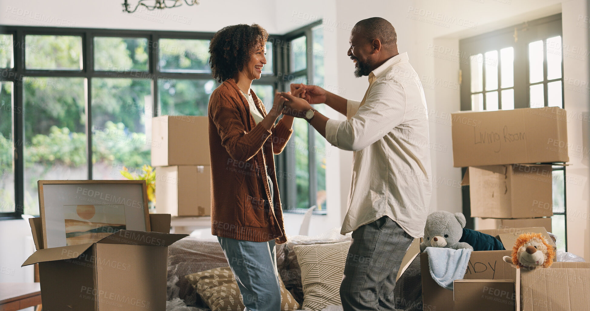 Buy stock photo Moving, dancing and mature couple in new home with boxes for bonding, love and fun together. Happy, marriage and man with woman for groove with celebration of property investment in apartment.