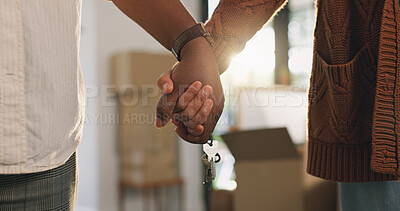 Buy stock photo Couple, holding hands and moving in home with key, property investment or support for real estate goal. Married people, love or keyring in dream house with relocation, mortgage loan or new beginning.