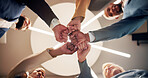 Business people, hands or unity with fist bump below for teamwork, solidarity or success together. Low angle, group or employees in circle with collaboration for mission, social cohesion or inclusion