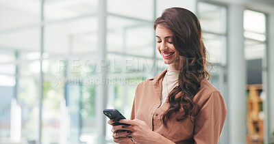 Buy stock photo Woman, phone and texting in lobby at startup with smile, contact and scroll with notification at media company. Person, smartphone and happy with mobile app, chat and feedback at creative agency