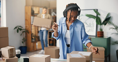 Buy stock photo Boxes, headphones and woman in office, startup for ecommerce and app for radio. Person, cardboard and entrepreneur in workplace, sound and listening to music, audio and checking for product barcode