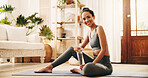 Portrait, water and yoga with woman in living room of home for break, holistic wellness or hydration. Bottle, drink and exercise with happy yogi person on floor in apartment for health activity 