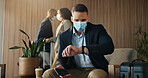 Wrist watch, face mask and business man in airport lounge for virus prevention, boarding delay and safety. Outbreak regulation policy, luggage and travel with person in vip lobby for time management