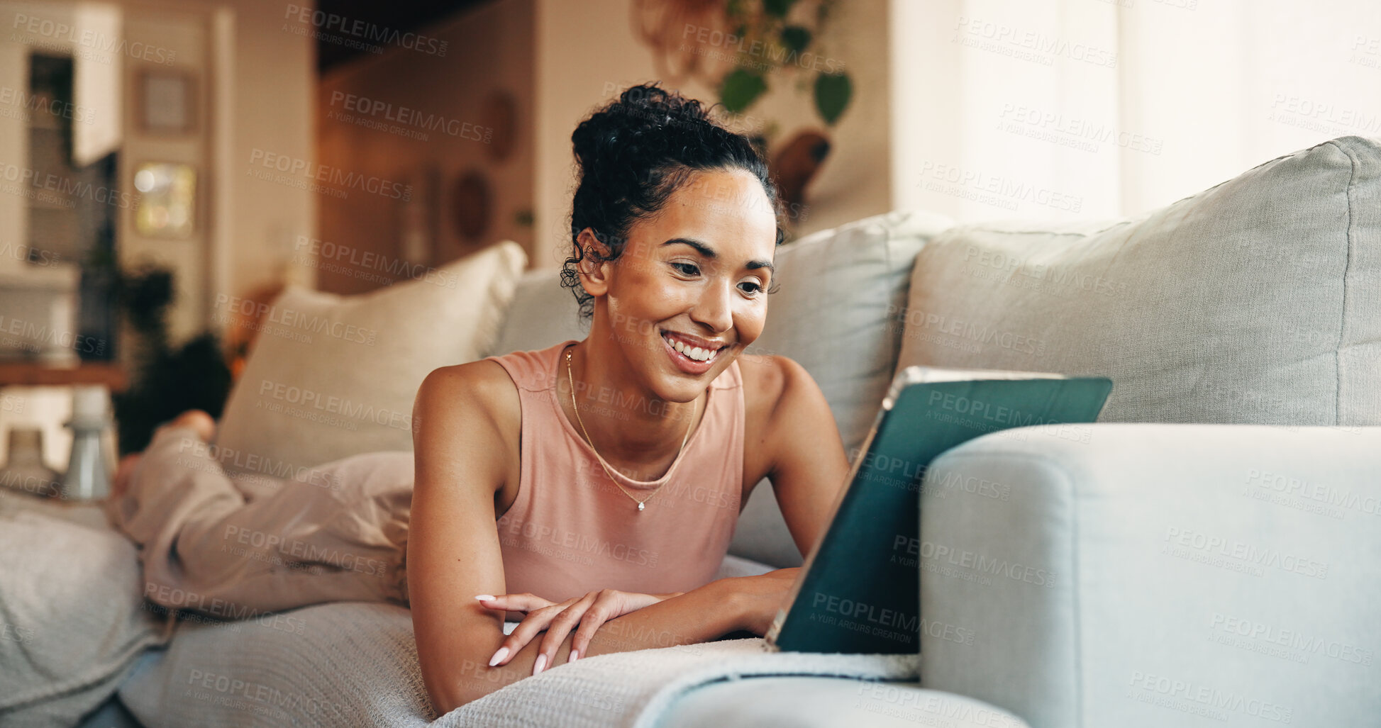 Buy stock photo Happy, woman and relax on sofa with tablet, watch social media video or online entertainment on weekend. Female person, smile and peace in home with tech, digital app and streaming website for movie.