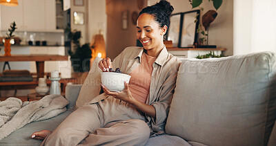 Buy stock photo Grapes, relax and smile of woman on sofa in living room of home for break, chilling or me time. Bowl, eating and fruit with happy person in apartment for morning meal, snack or weekend nutrition