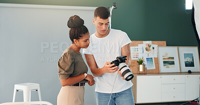 Buy stock photo Talking, photographer and model with camera in studio, review image and tips for expression check. Photography, creative or people with discussion for picture selection, production or photoshoot idea