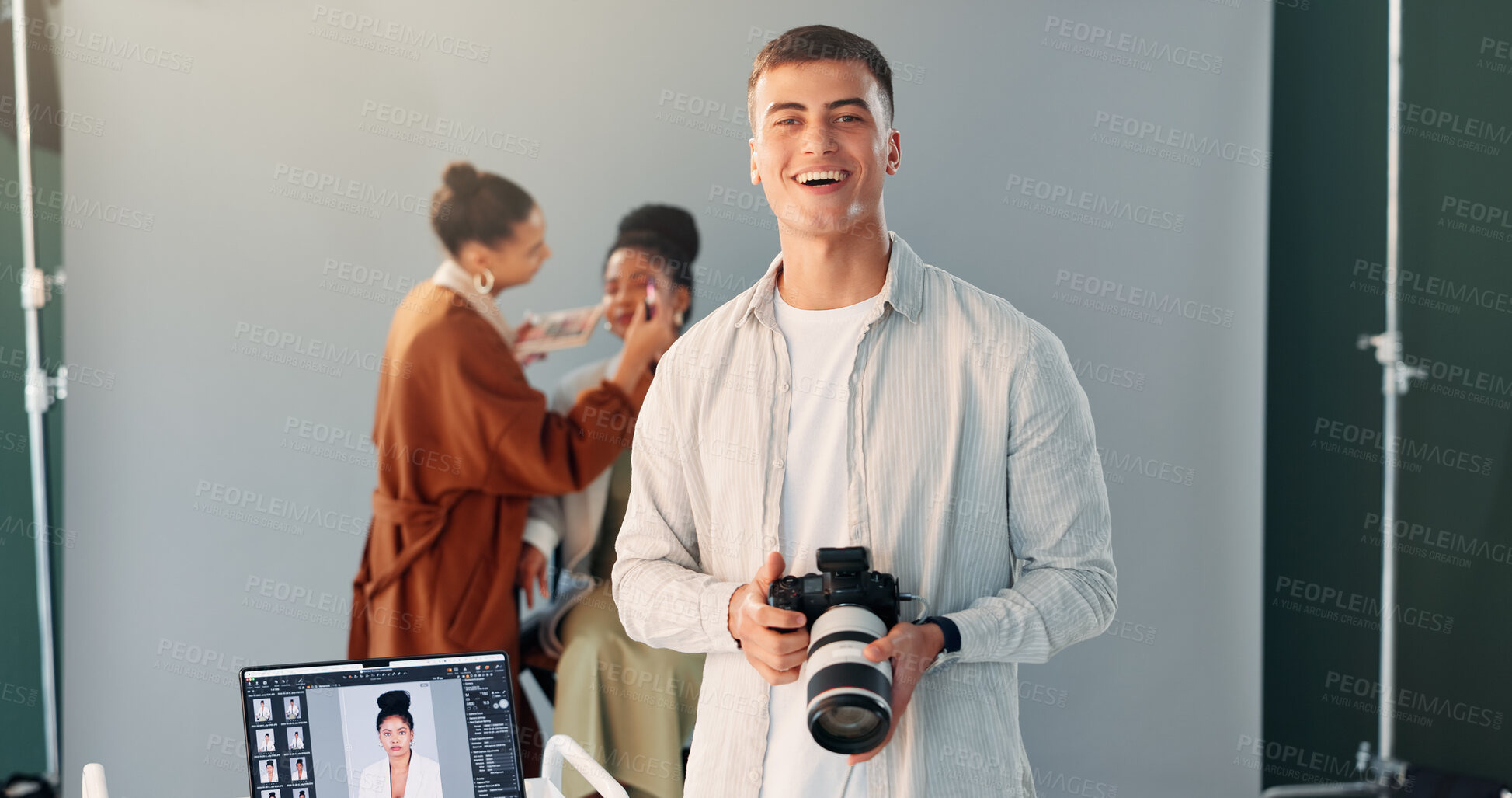 Buy stock photo Photographer, portrait and man with camera, studio and creative team in backstage or post production. Happy, artist and person with tech for photography, behind the scenes and setup for photoshoot