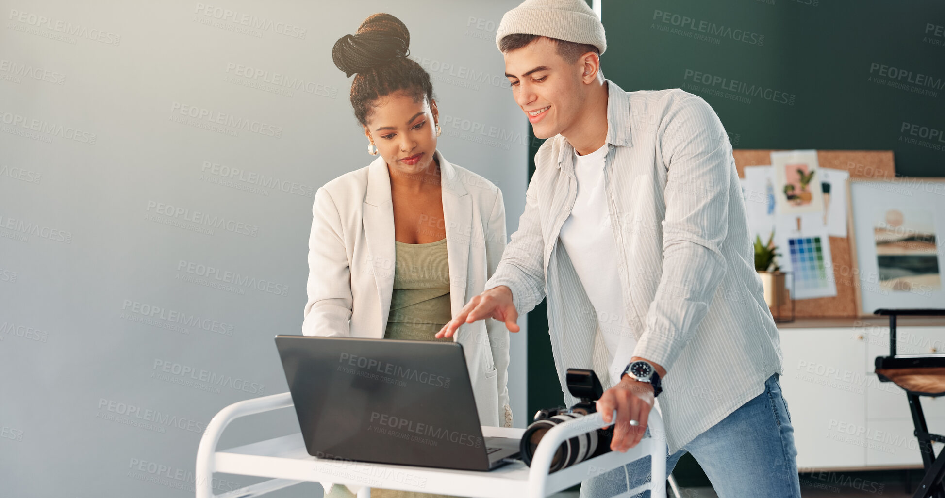 Buy stock photo Laptop, photography and talking with people in studio together for feedback or production planning. Computer, photoshoot or teamwork with photographer man and woman on set for film or media review