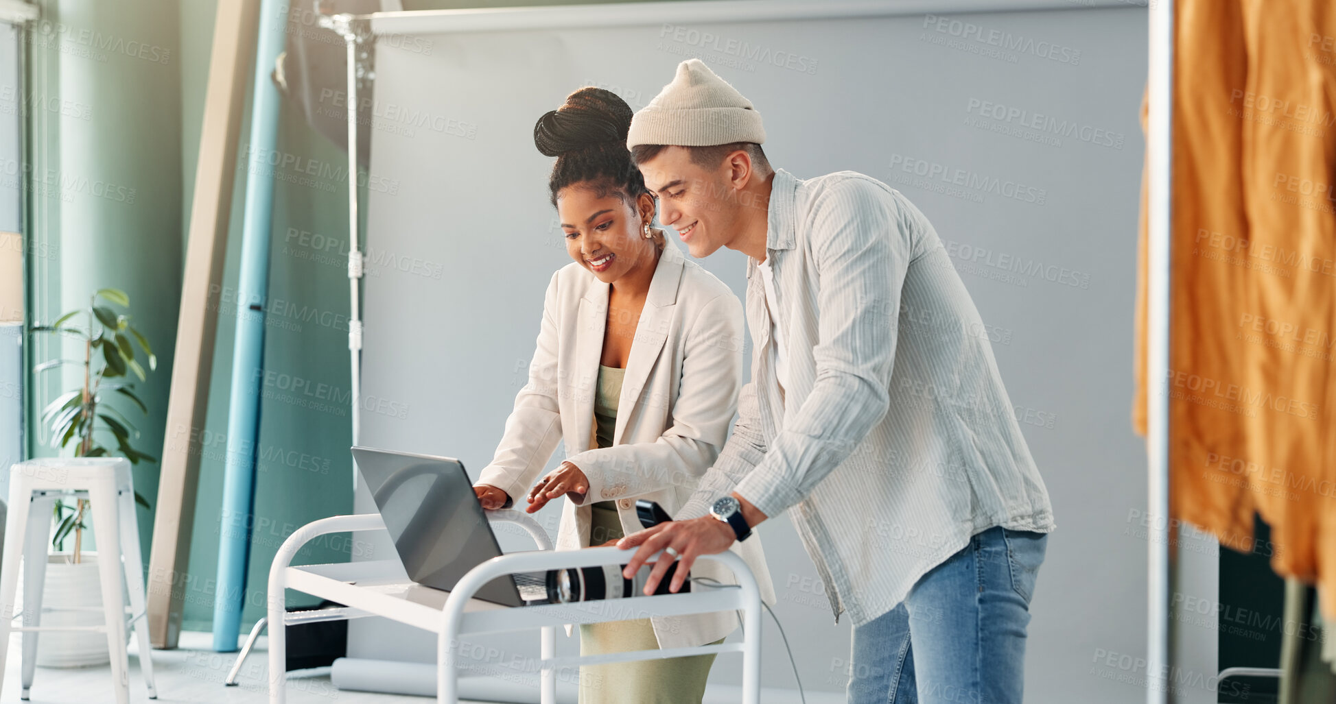 Buy stock photo Laptop, photography and teamwork with people in studio together for feedback or production planning. Computer, discussion or photoshoot with happy photographers on set for film or media review