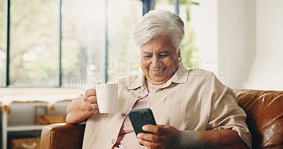 Buy stock photo Coffee, laughing and phone with senior woman on sofa in home for retirement or social media. App, drinking and funny with happy old person in living room of apartment for browsing or communication