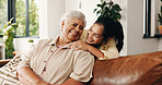 Hug, smile or visit with old woman and daughter on sofa in home together for bonding or love. Family, security or trust with adult child and senior parent embracing in living room of apartment