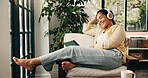 Headphones, smile and woman with tablet in house, streaming move website and comfort series to relax. Tech, rest or mature person with subscription service to watch film, podcast video and audiobook
