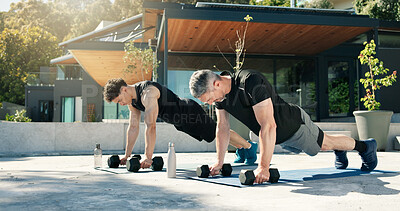 Buy stock photo Bodybuilder, men and outdoor with dumbbells for fitness, muscle development and health. Personal trainer, training and people with weights for exercise by home with push up, challenge and workout