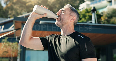 Buy stock photo Outdoor, athlete and man with water, fitness and body recovery after exercise routine, rest and home. Drinking, liquid and mature person with bottle for hydration, thirsty and wellness with detox