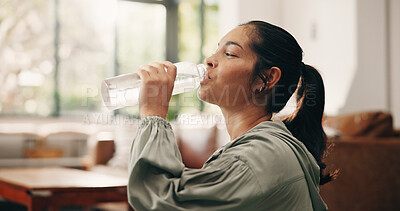 Buy stock photo Woman, relax or drinking water in living room with bottle, wellness or natural detox for gut health. Thirsty, mature person and liquid beverage in home with hydration, nutrients or digestion benefits