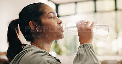 Buy stock photo Thirsty, woman and drinking water in home with bottle, wellness and natural detox for gut health. Flare, mature person and liquid beverage in lounge with hydration, nutrients and digestion benefits.