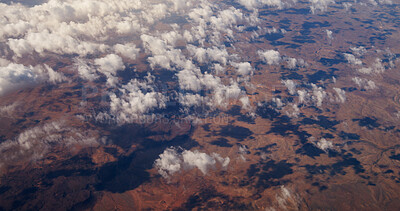 Buy stock photo Aerial view, clouds and landscape with mountains, nature and shadow on ground, outdoor and earth in summer. Above, horizon and weather with terrain, hills and environment in rural countryside