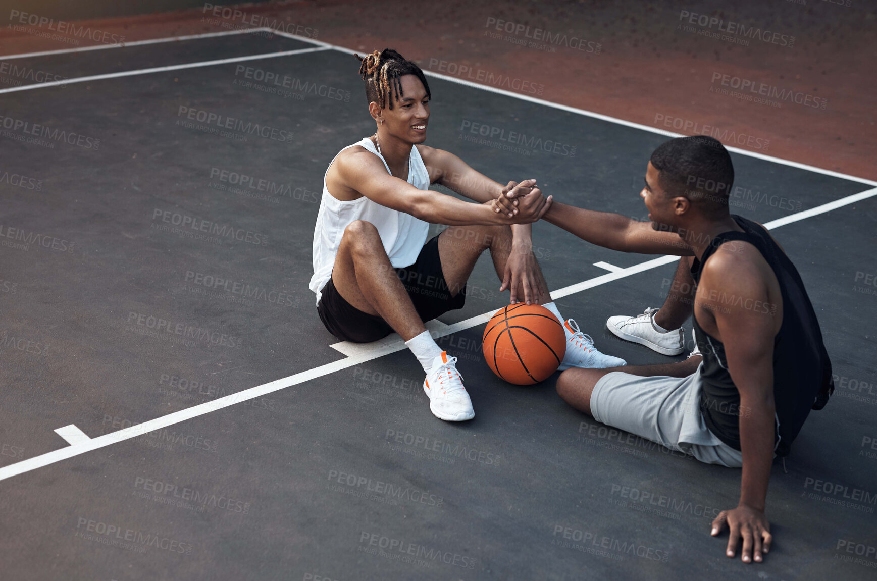 Buy stock photo Happy, friends and relax on basketball court with handshake, exercise break or support for fitness. People, smile and shaking hands outdoor with wellness, workout rest or teamwork for sports practice