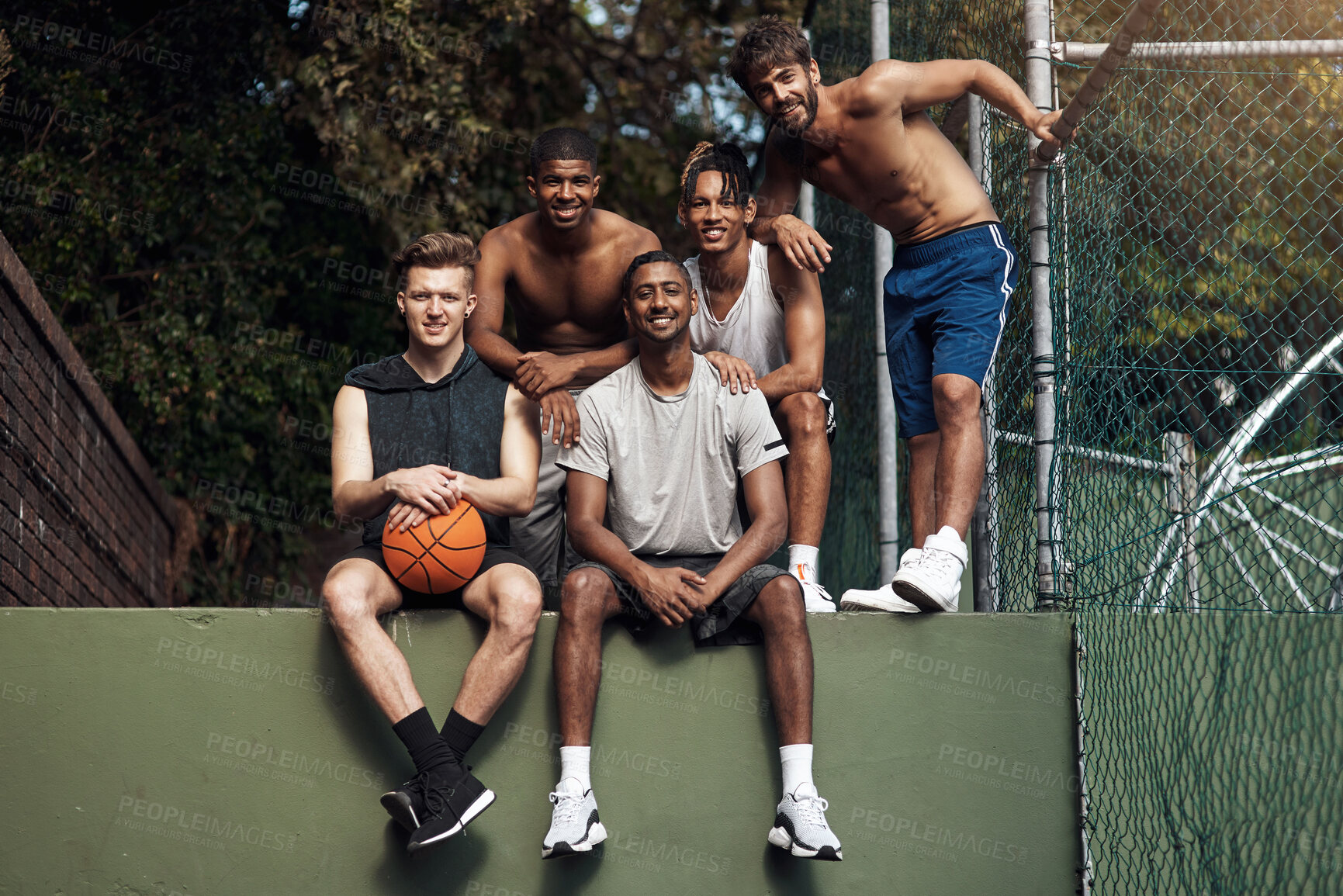 Buy stock photo Basketball court, smile and portrait with friends on wall for sports, exercise or training break outdoors. Athlete, people and relax together for bonding, hobby and rest from practice match or game