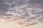 Sunset, orange and sky with clouds for weather, atmosphere and empty space. Natural, background and air with sunshine in evening for aesthetic, wallpaper and scenic view for nature or climate