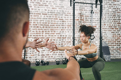 Buy stock photo Woman, squat and exercise with personal trainer in gym, wellness or training together for body goals. Health club, coach and workout routine with people, fitness and balance for muscle development