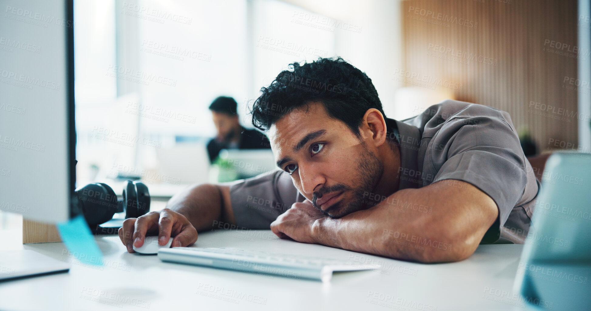 Buy stock photo Bored, employee and man with computer, office and reporter with article on web, creative and fatigue. Newsroom, burnout and person with low energy for story submission, online and exhausted on table