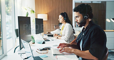 Buy stock photo Call center, computer and man in workplace, typing for customer service and headset for communication. Person, talking and employees in office, pc or discussion for online assistance and consultation