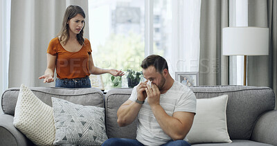 Buy stock photo Couple, argument and fight with disagreement on sofa for emotional breakup or divorce in home. Sad, man and woman with tissue for toxic relationship, conflict or living room dispute together in house