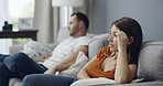 Argument, conflict and couple on sofa in home with relationship problem, cheating or affair. Fighting, conversation and man with woman for marriage disagreement for divorce in living room at house.