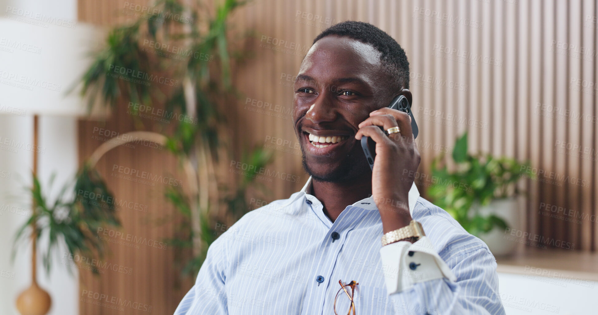 Buy stock photo Laughing, employee and man in office, phone call and talking with contact for real estate investment. Happiness, realtor and black person with mobile for communication, good news and property sale