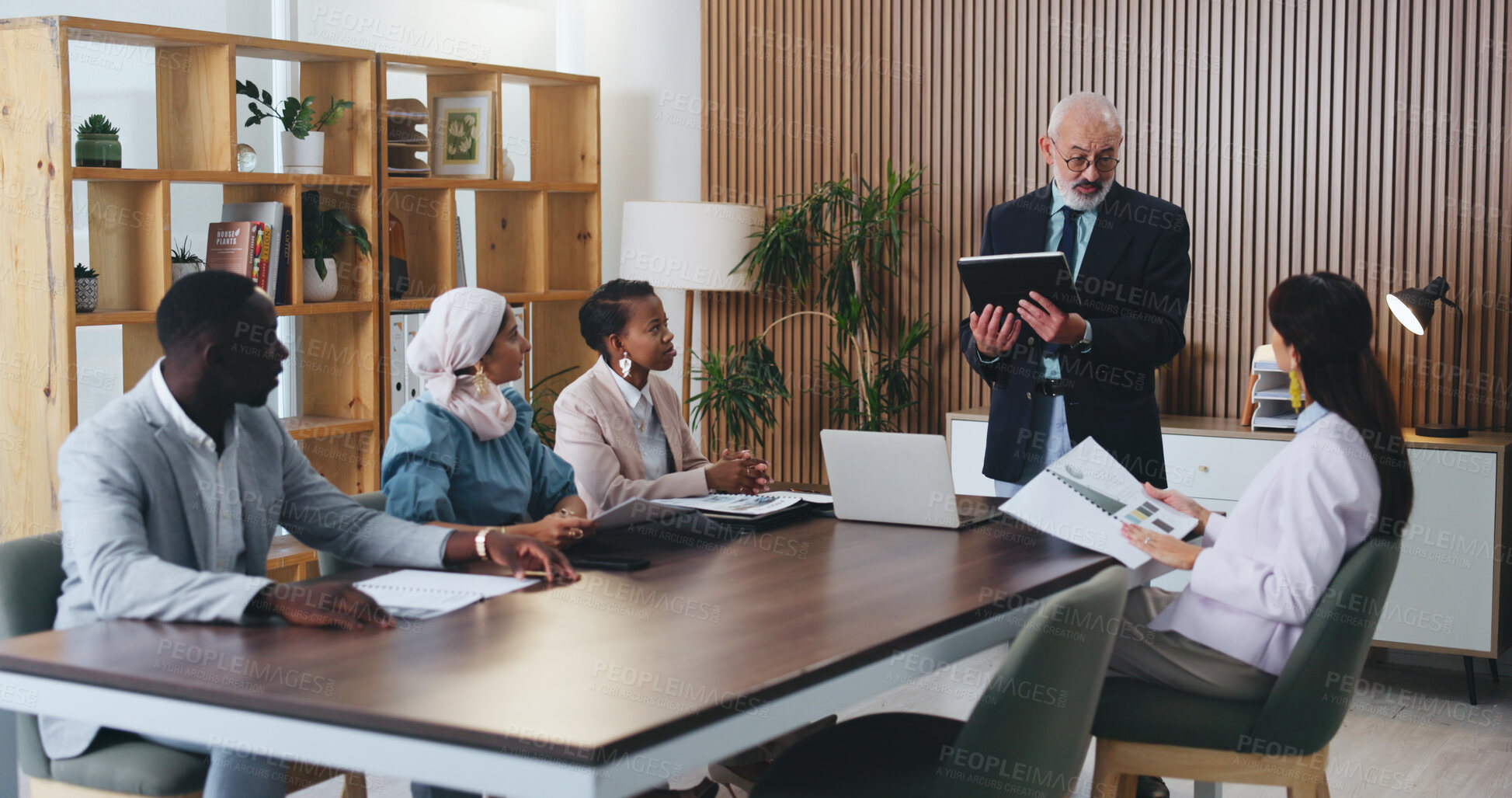 Buy stock photo Man, tablet and speaker with team in office meeting for planning with review, insight or talk at insurance company. Person, broker and group with tech on app, feedback or risk management at agency