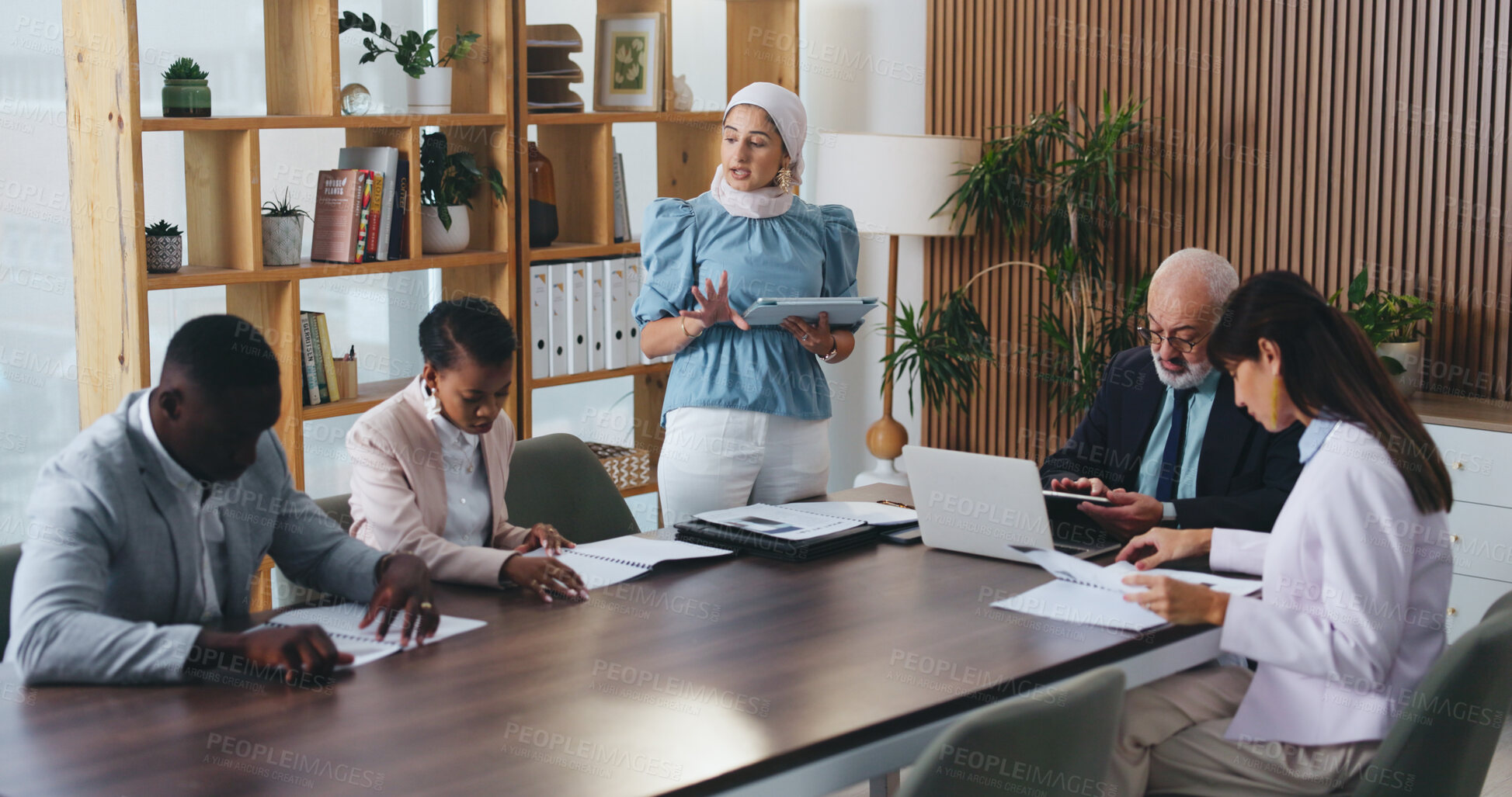 Buy stock photo Woman, tablet and discussion with team in office meeting on app with review, insight or talk at insurance company. Person, speaker and tech for group, feedback or risk management report at agency